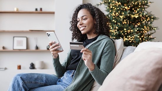 Woman making a mobile purchase with a WaFd Bank credit card.