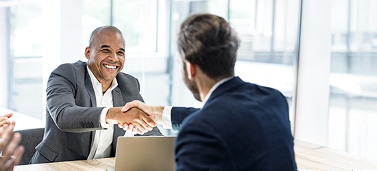 Businessmen shaking hands at a meeting in the office.