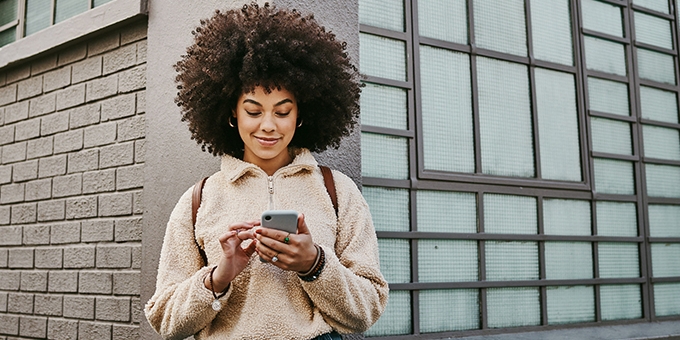 Woman using her cellphone while out in the city