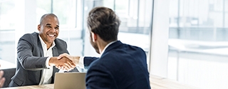 Businessmen shaking hands at a meeting in the office.