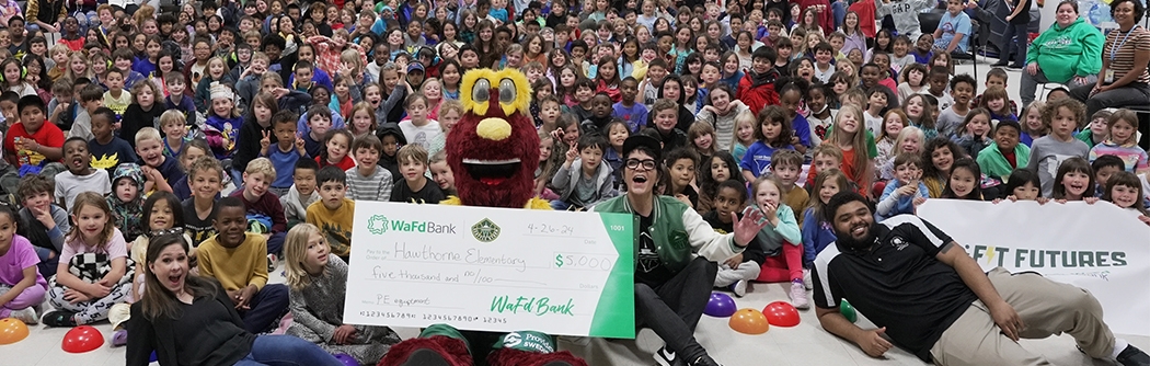 WaFd Bank presenting a check to Hawthorne Elementary with Seattle Storm as part of the Fit Futures program.