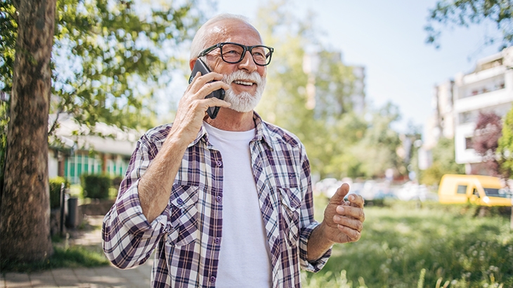 Mature man outside on a mobile phone.