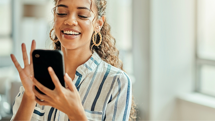 Businesswoman using a mobile phone to look at social media.