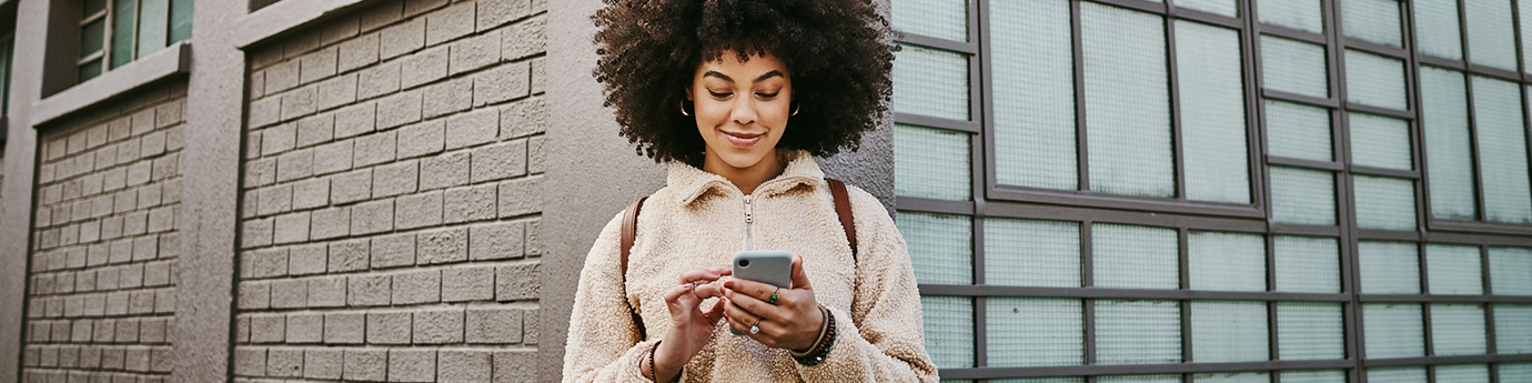 Woman using her cellphone while out in the city