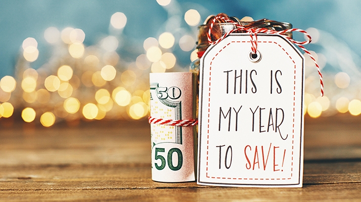 Money tied in string and holiday gift tag saying "This is my year to save!".