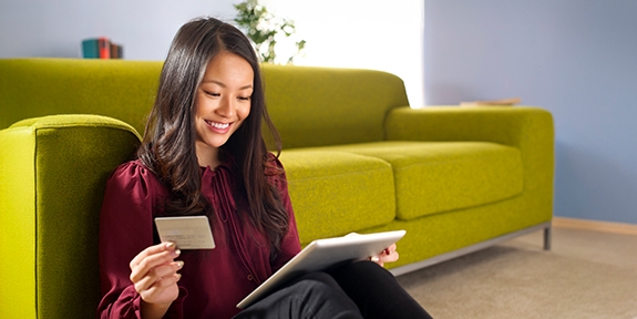 Woman making a credit card purchase on her tablet.