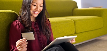 Woman making a credit card purchase on her tablet.