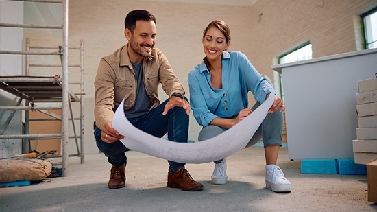 Couple reviewing architectural plans.