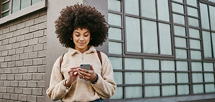 Woman using her cellphone while out in the city