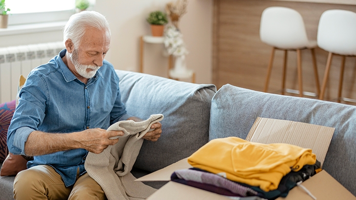 Mature man packing to move.