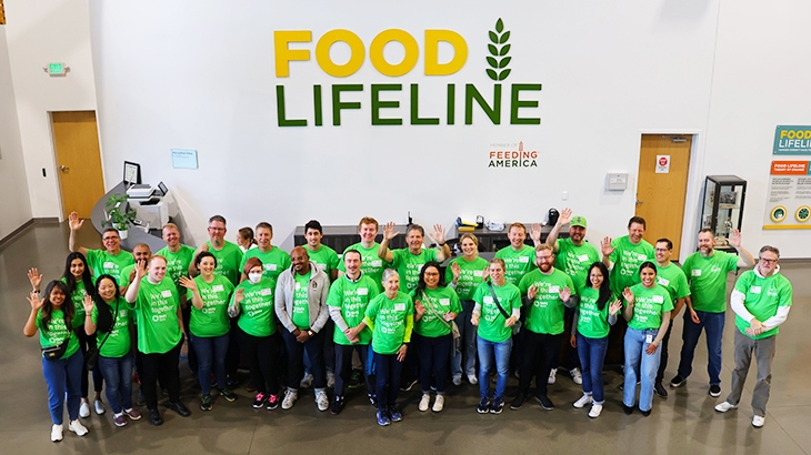 A diverse group of WaFd employees at the Food Lifeline building.