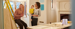 A young family choosing a new paint color for their living room.