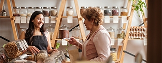 Happy employee and customer smiling at each other.