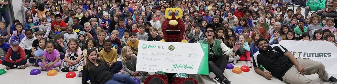 WaFd Bank presenting a check to Hawthorne Elementary with Seattle Storm as part of the Fit Futures program.