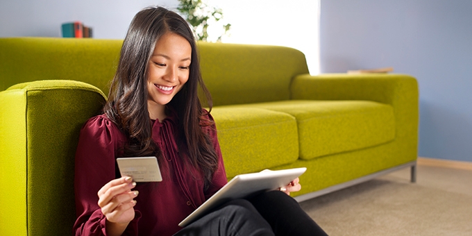 Woman making a credit card purchase on her tablet.