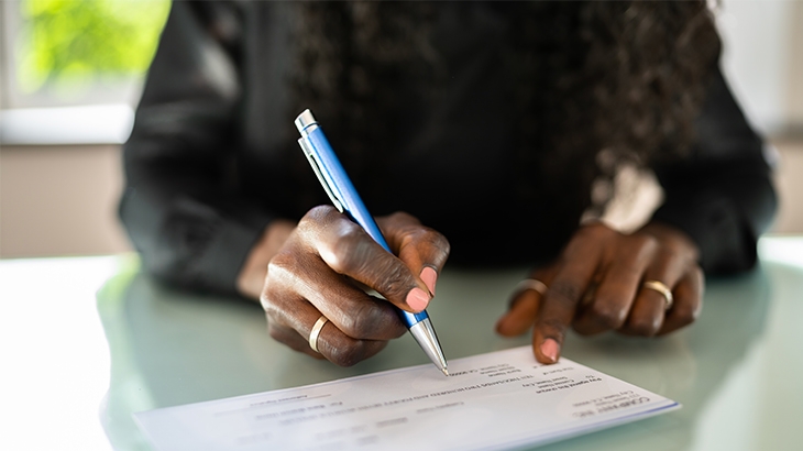 Woman writing a check.