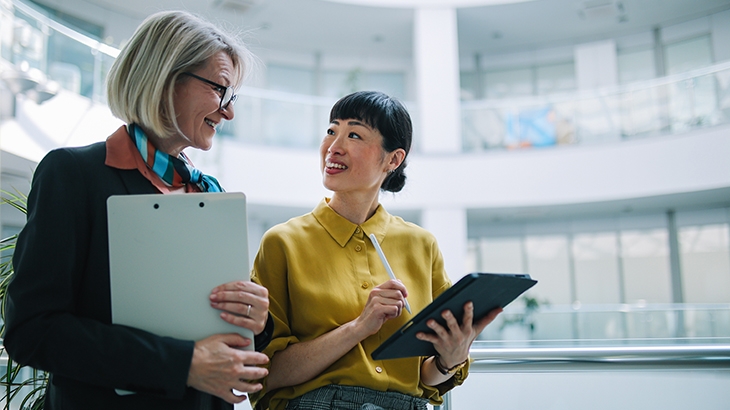 Senior manager discussing work with an employee.