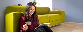 Woman making a credit card purchase on her tablet.