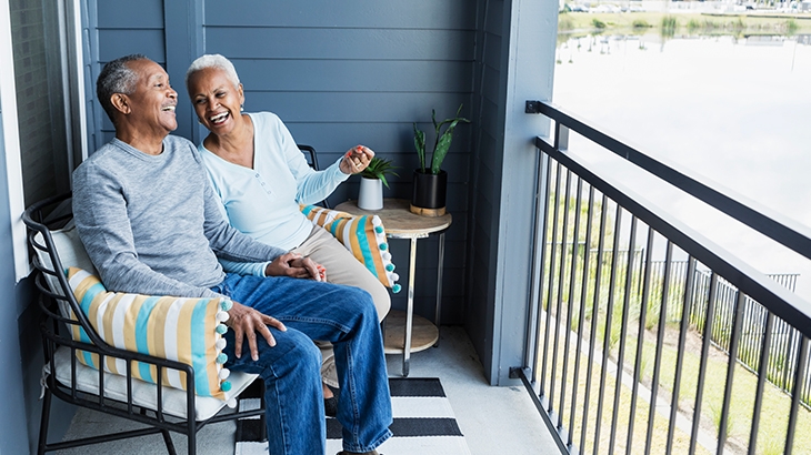 Mature couple sitting on their veranda.