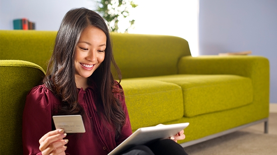 Woman making a credit card purchase on her tablet.